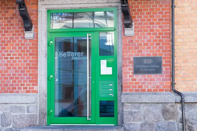 Grüne Eingangstür in einer Klinkerfassade