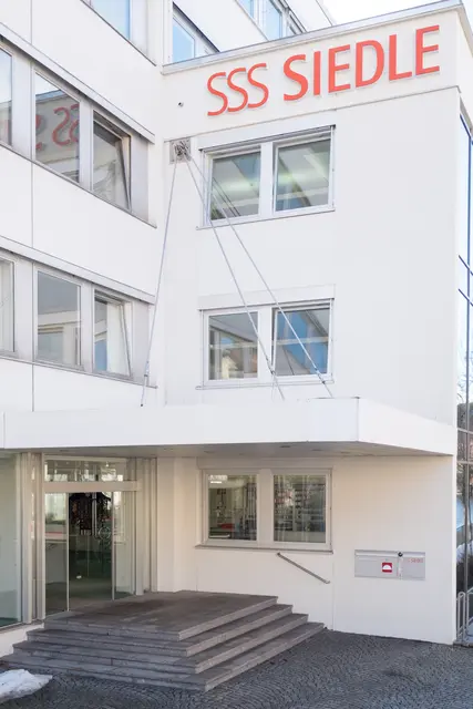 Fenster an einem weißen Mehrfamilienhaus