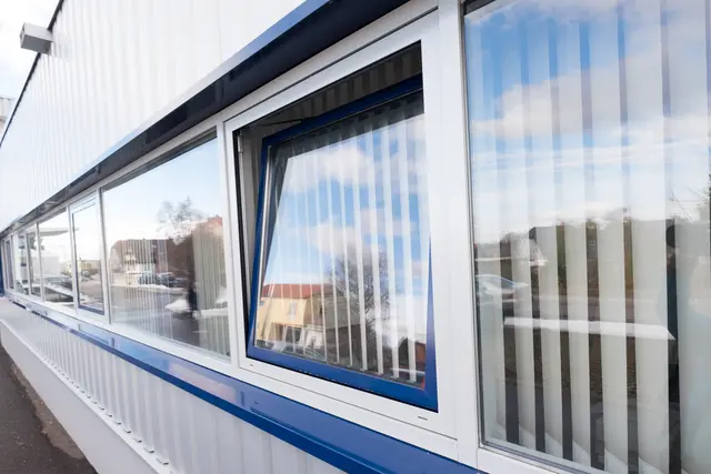 Fensterband mit blauer Rahmung an einer Halle