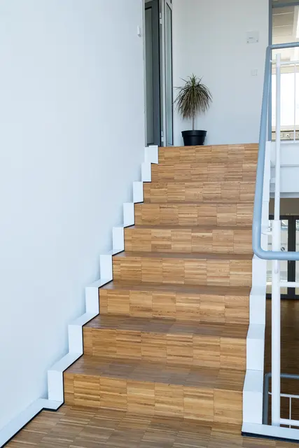 Moderne gerade Holztreppe mit weißem Geländer